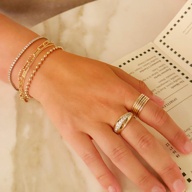Model wearing Five Golden Rings with solid gold Stone and Strand jewelry