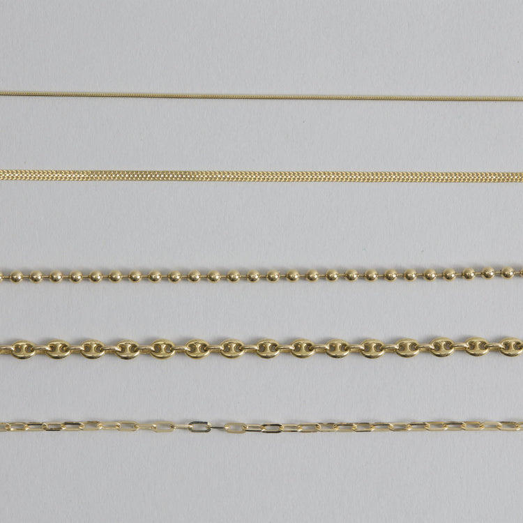 Still life image of Flat Arrow Chain Necklace with Stone and Strand solid gold jewelry