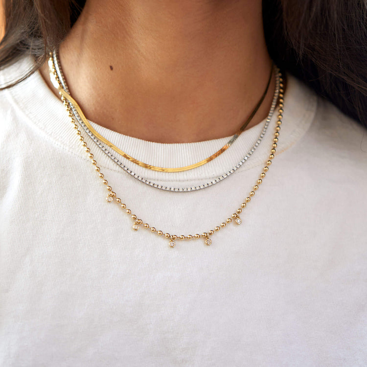Model wearing Bedazzle Diamond Necklace with solid gold Stone and Strand jewelry