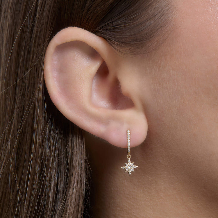 Image of 14K Yellow Gold Northern Star Pave Huggies on Models Ear