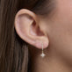 Image of 14K Yellow Gold Northern Star Pave Huggies on Models Ear