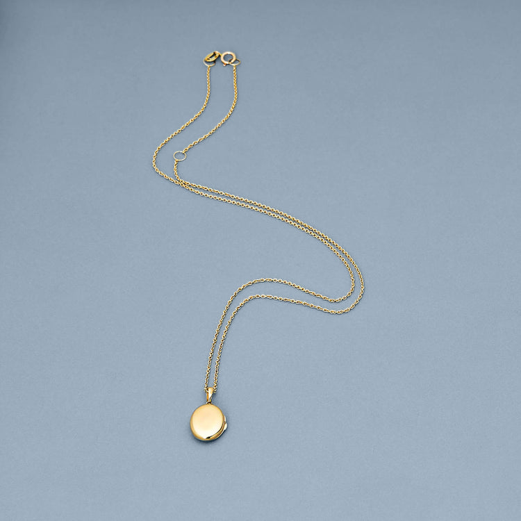 Stone and Strand 14K Yellow Gold Oval Essenital Locket Charm Editorial Image