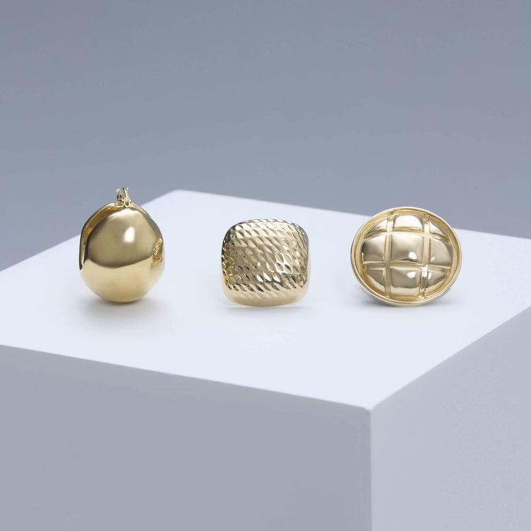 Still life image of Ultra Puff Gold Huggies with Stone and Strand solid gold jewelry