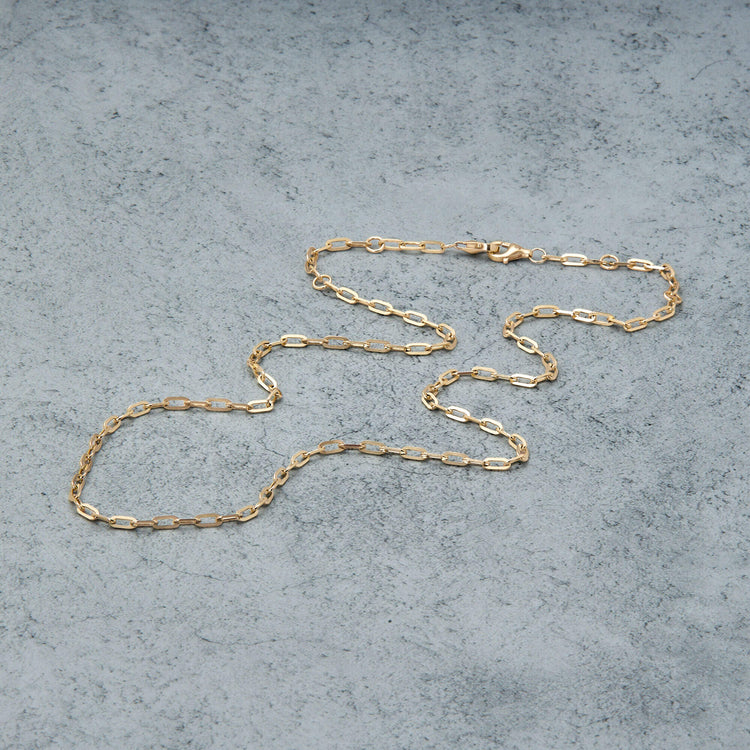Stone and Strand 14K Yellow Gold Pivot by Stone and Strand Paperclip Chain Editorial Image