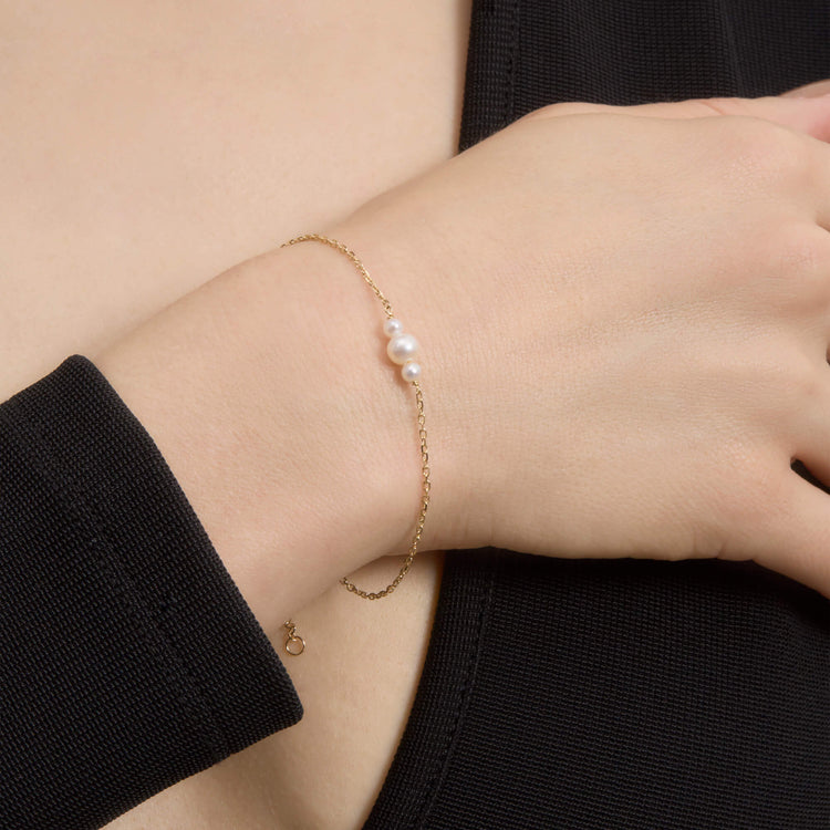 Image of 14K Yellow Gold Pearl Trio Bracelet on Models Arm