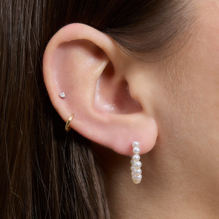 Image of 10K Yellow Gold Pearly Huggies on Models Ear