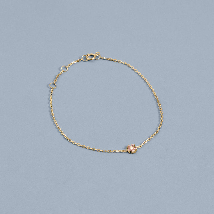 Stone and Strand 10K Yellow Gold Pink Sapphire Flower Bracelet Editorial Image