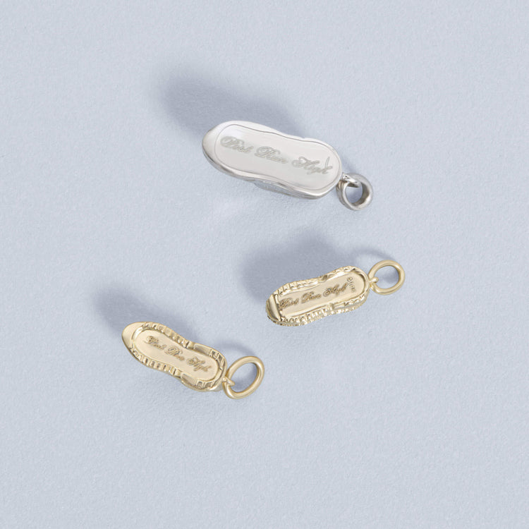 Still life image of Post Run High Silver Charm with Stone and Strand solid gold jewelry