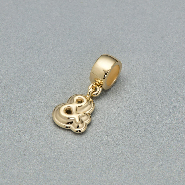 Stone and Strand 14K Yellow Gold Puffed Ampersand Charm Editorial Image
