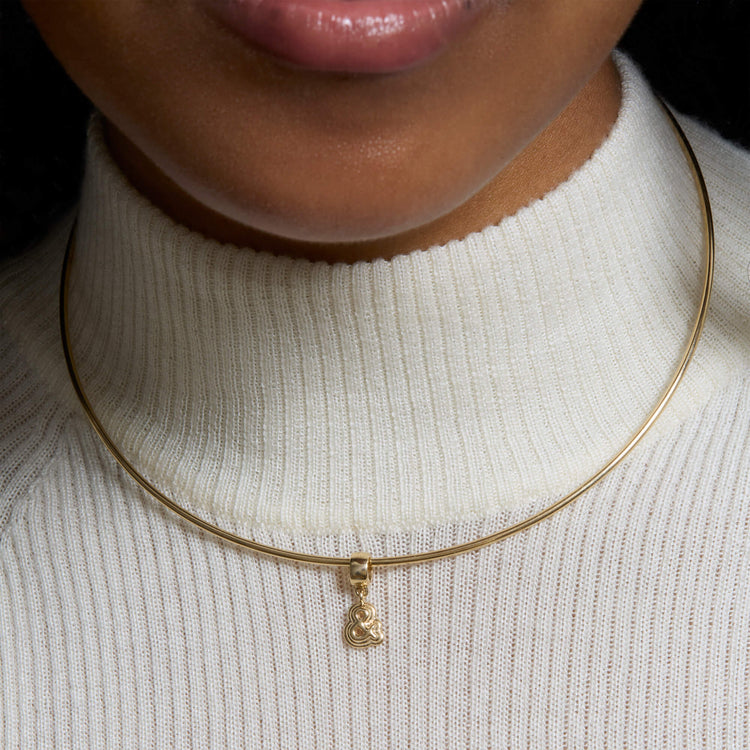 Image of 14K Yellow Gold Puffed Ampersand Charm on Models Neck