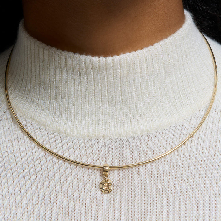 Image of 14K Yellow Gold Puffed initial Charm with Gold Grand Collar on Models Neck