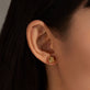 Image of 14K Yellow Gold Puffed Knot Studs on Models Ear