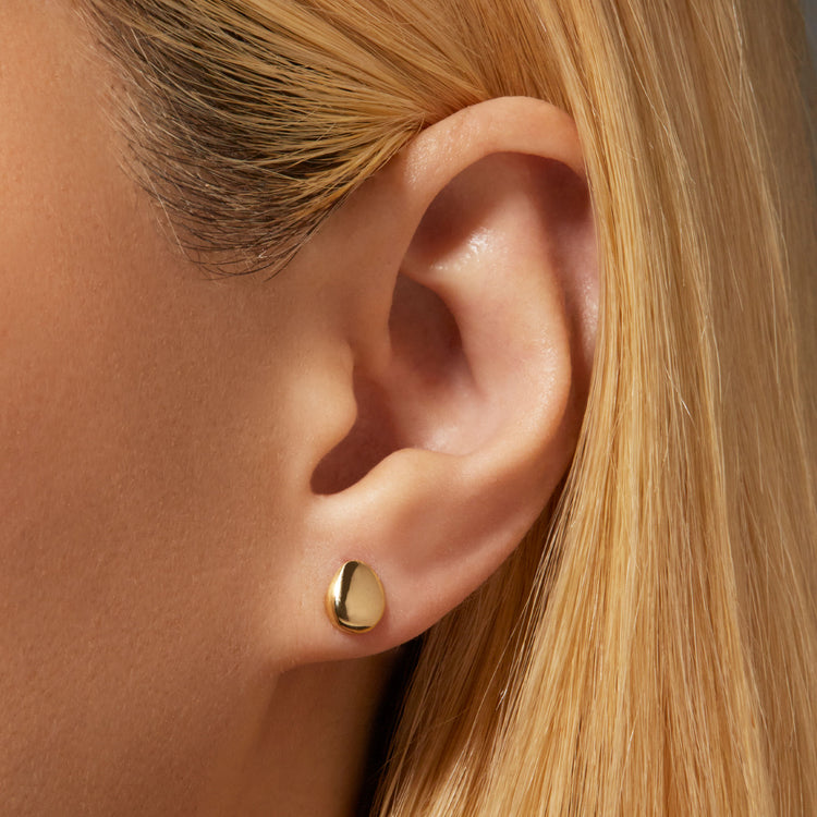 Image of 14K Yellow Gold Puffed Ovo Studs on Models Ear