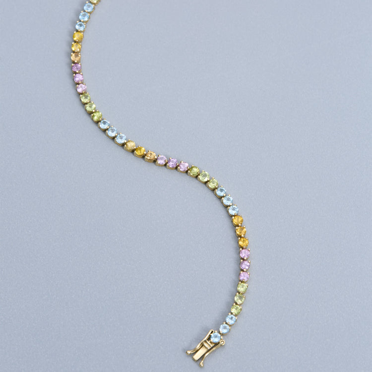 Stone and Strand 10K Yellow Gold Rainbow Bright Tennis Gemstone Bracelet Editorial Image