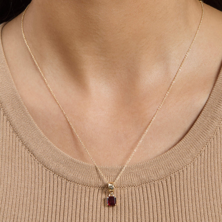 Image of 10K Yellow Gold Red Studio Garnet Charm Necklace on Models Neck
