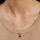 Image of 10K Yellow Gold Red Studio Garnet Charm Necklace on Models Neck