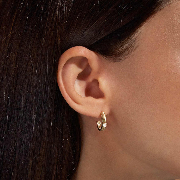 Image of 10K Yellow Gold Dainty Diamond Pirouette Hoops on Models Ear