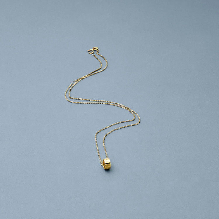 Stone and Strand 14K Yellow Gold Ridged Rondelle Charm Editorial Image