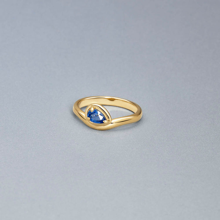 Stone and Strand 10K Yellow Gold Blue Sapphire Raindrop Merge Ring Editorial Image