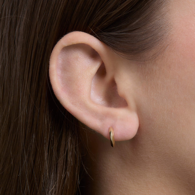 Image of 14K Yellow Gold Second Hole Gold Knife Edge Single Huggie on Models Ear