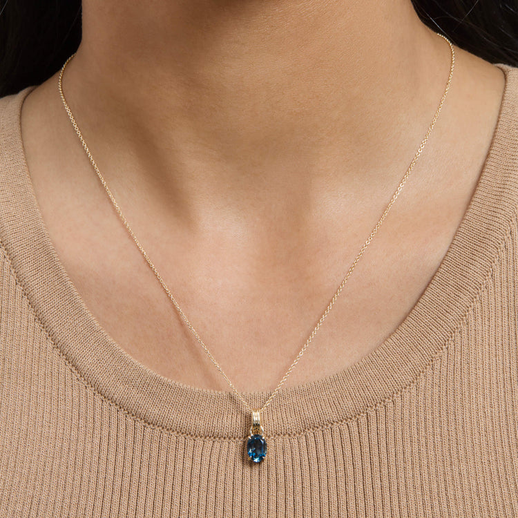 Image of 14K Yellow Gold Serenity Topaz Mood Charm on Models Neck
