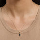 Image of 14K Yellow Gold Serenity Topaz Mood Charm on Models Neck