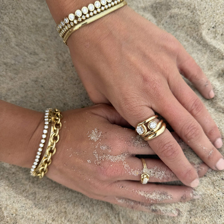 Model wearing Serpente Bracelet with solid gold Stone and Strand jewelry