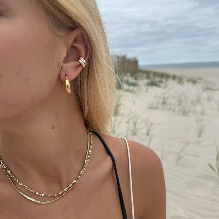 Model wearing Serpente Necklace with solid gold Stone and Strand jewelry