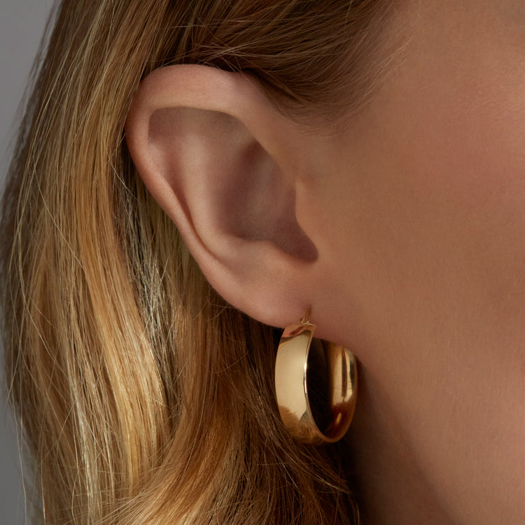 Image of 10K Yellow Gold Medium Gold Glider Hoops on Models Ear