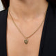 Image of 14K Yellow Gold Small Gold Initial Crest Charm on Models Neck