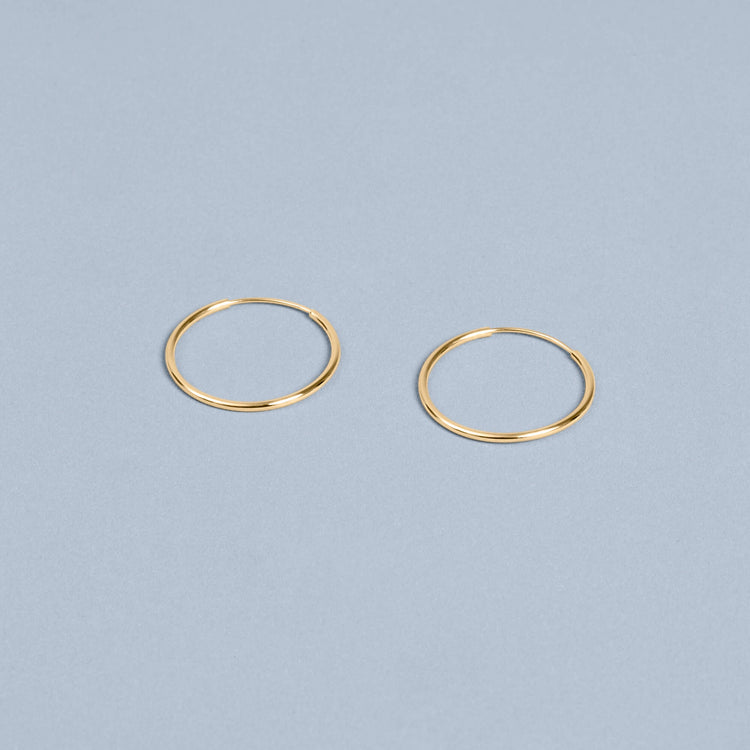 Stone and Strand 10K Yellow Gold Small Round Endless Hoop Earrings Editorial Image