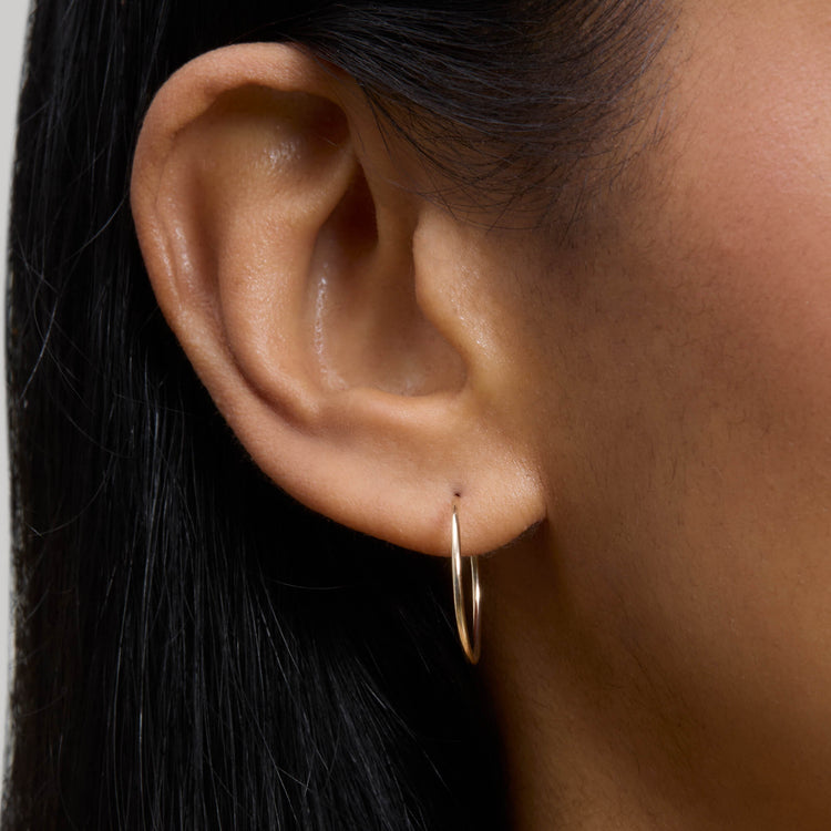 Image of 10K Yellow Gold Small Round Endless Hoop Earrings on Models Ear