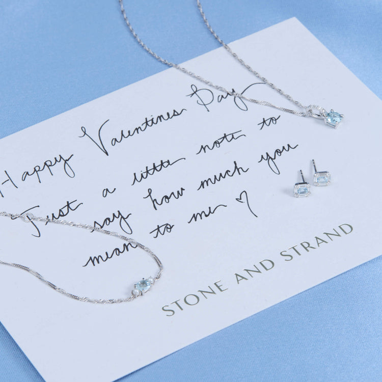 Still life image of Aquamarine Shield Of Strength Earrings with Stone and Strand solid gold jewelry