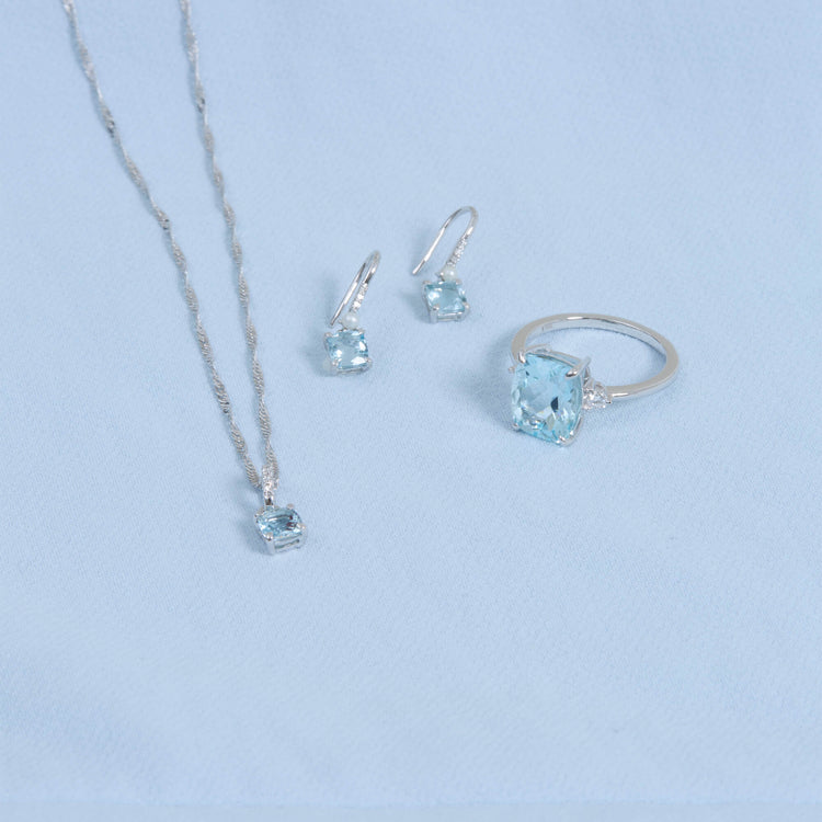 Still life image of Cushion Cut Aquamarine and Pearl Drop Earrings with Stone and Strand solid gold jewelry
