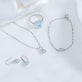 Still life image of Cushion Cut Aquamarine and Pearl Drop Earrings with Stone and Strand solid gold jewelry