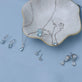 Still life image of Cushion Cut Aquamarine and Pearl Drop Earrings with Stone and Strand solid gold jewelry