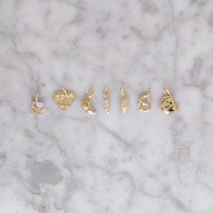 Still life image of Diamond Baguette Charm with Stone and Strand solid gold jewelry