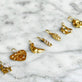 Still life image of Diamond Baguette Charm with Stone and Strand solid gold jewelry