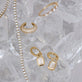 Still life image of Emerald Cut LAB-Created Diamond Huggies with Stone and Strand solid gold jewelry