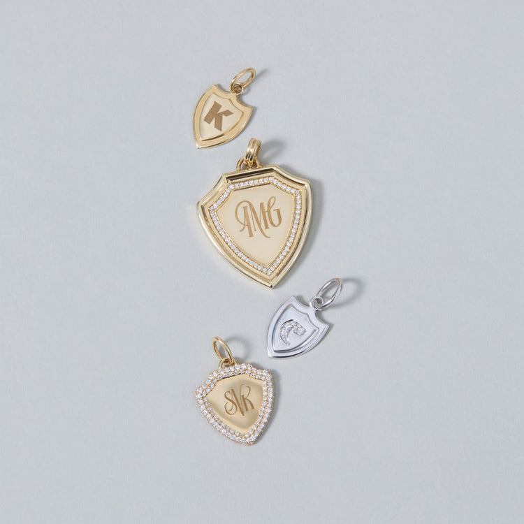 Still life image of Founding Member Diamond Crest Charm with Stone and Strand solid gold jewelry
