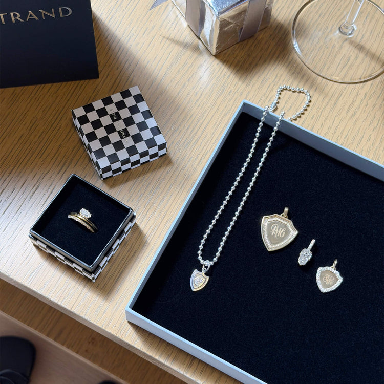 Still life image of Founding Member Diamond Crest Charm with Stone and Strand solid gold jewelry