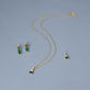 Still life image of Full Volume Emerald Drop Earrings with Stone and Strand solid gold jewelry