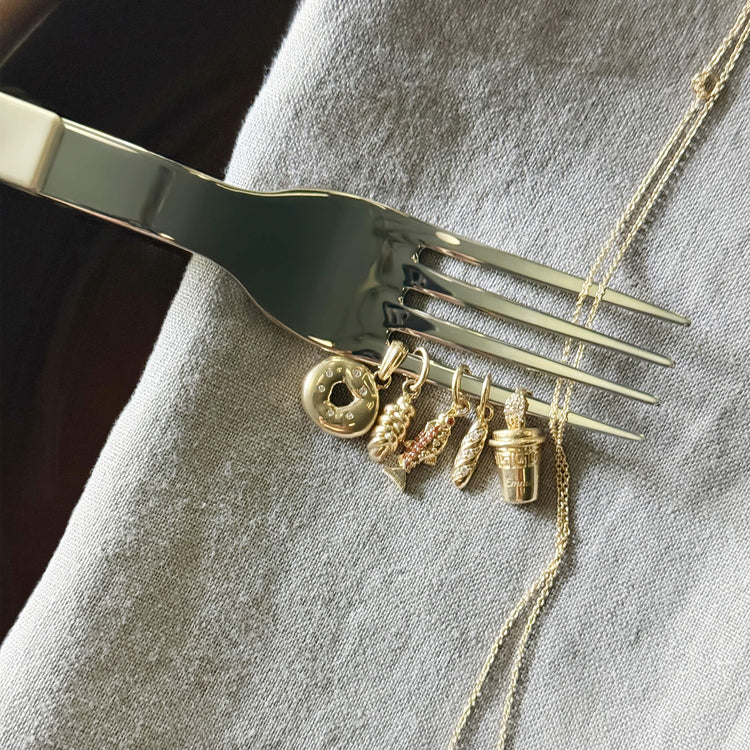 Still life image of Gold Coffee Brunch Charm with Stone and Strand solid gold jewelry