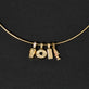 Still life image of Gold Salmon Charm with Stone and Strand solid gold jewelry