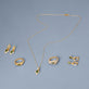 Still life image of Green Tourmaline Diamond Power Huggies with Stone and Strand solid gold jewelry