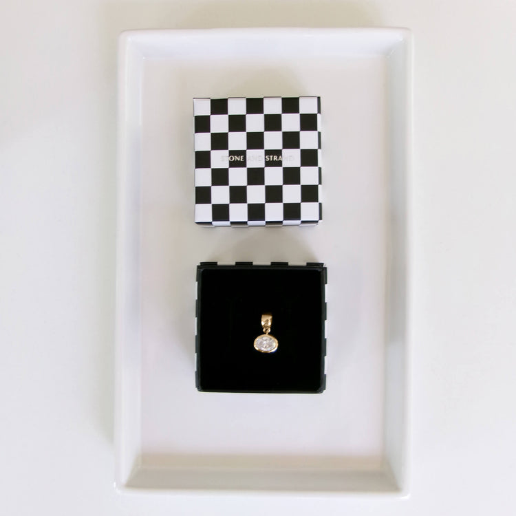 Still life image of Lab-Created Oval Diamond Charm with Stone and Strand gift box