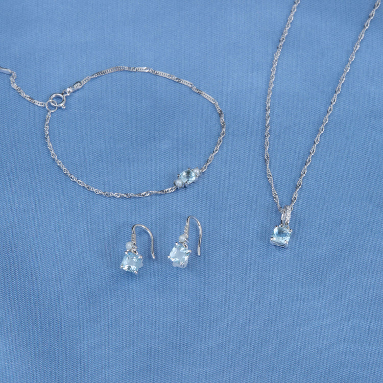 Still life image of Le Bleu Cushion Cut Aquamarine Pendant with Stone and Strand solid gold jewelry