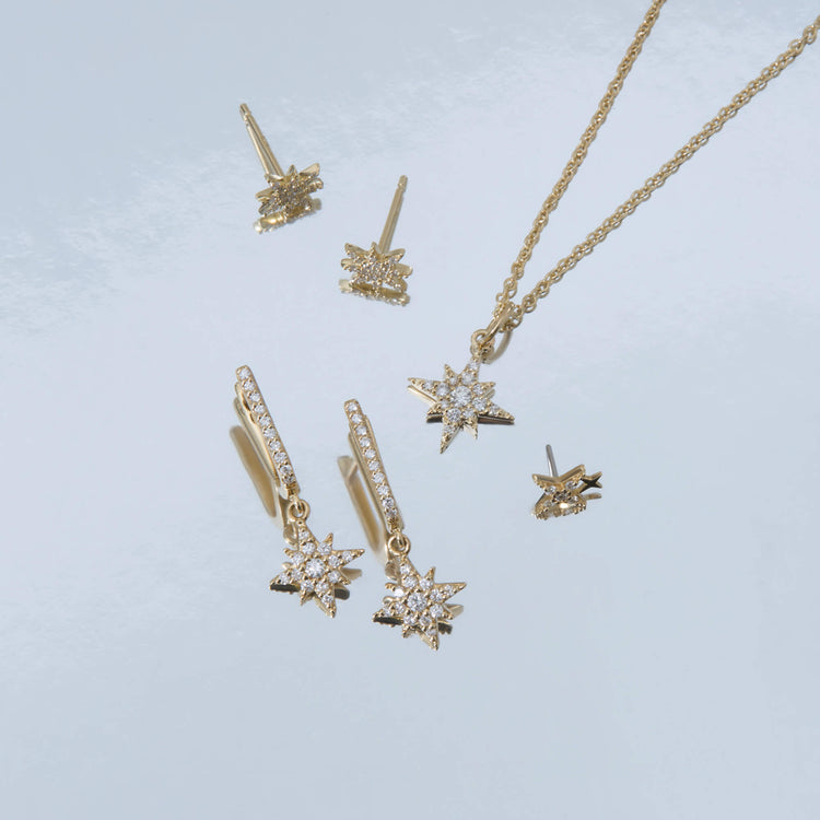 Still life image of Northern Star Pave Huggies with Stone and Strand solid gold jewelry