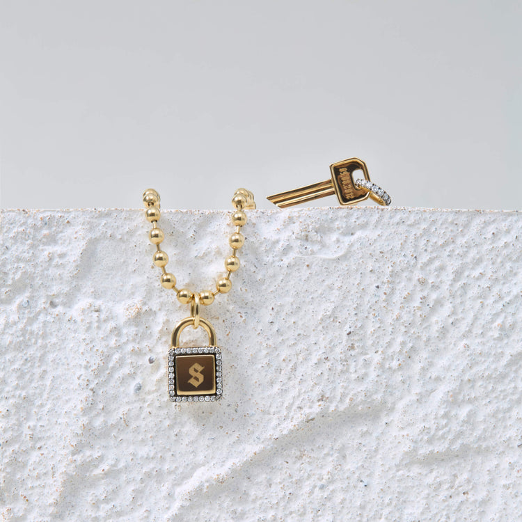 Still life image of Almost Forever Pave Key Charm with Stone and Strand solid gold jewelry