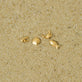 Still life image of Scallop Shell Flat Back Piercing Earring with Stone and Strand solid gold jewelry